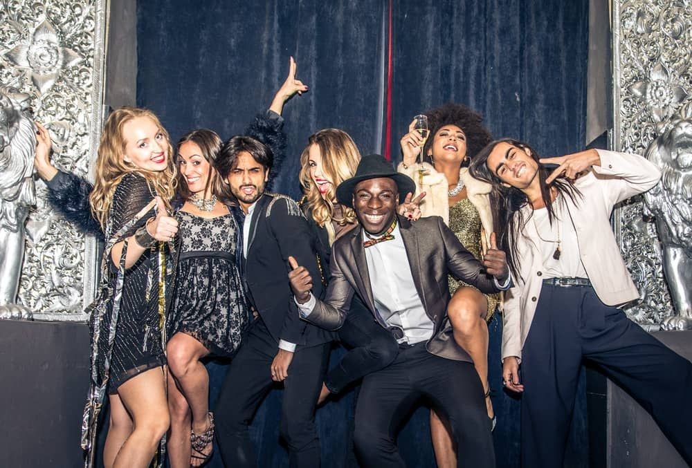 Group enjoying a company holiday party in a Las Vegas club, showcasing a lively and diverse office celebration with festive attire.